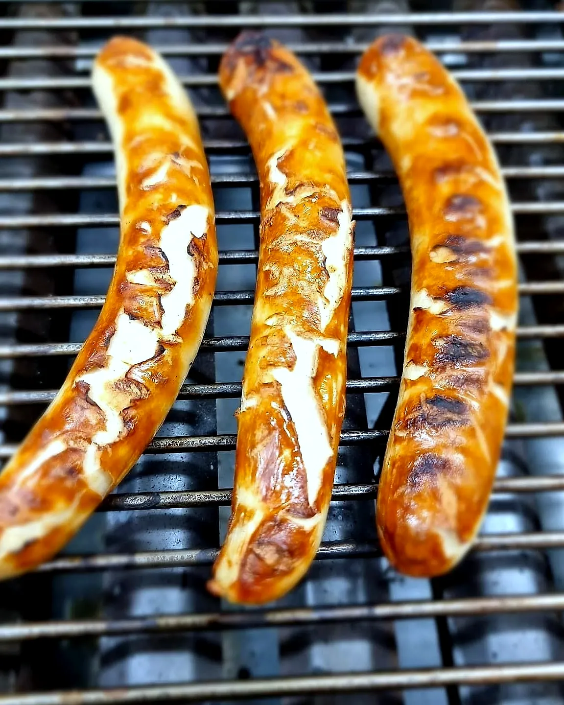 Drei Bratwürste auf dem Grill